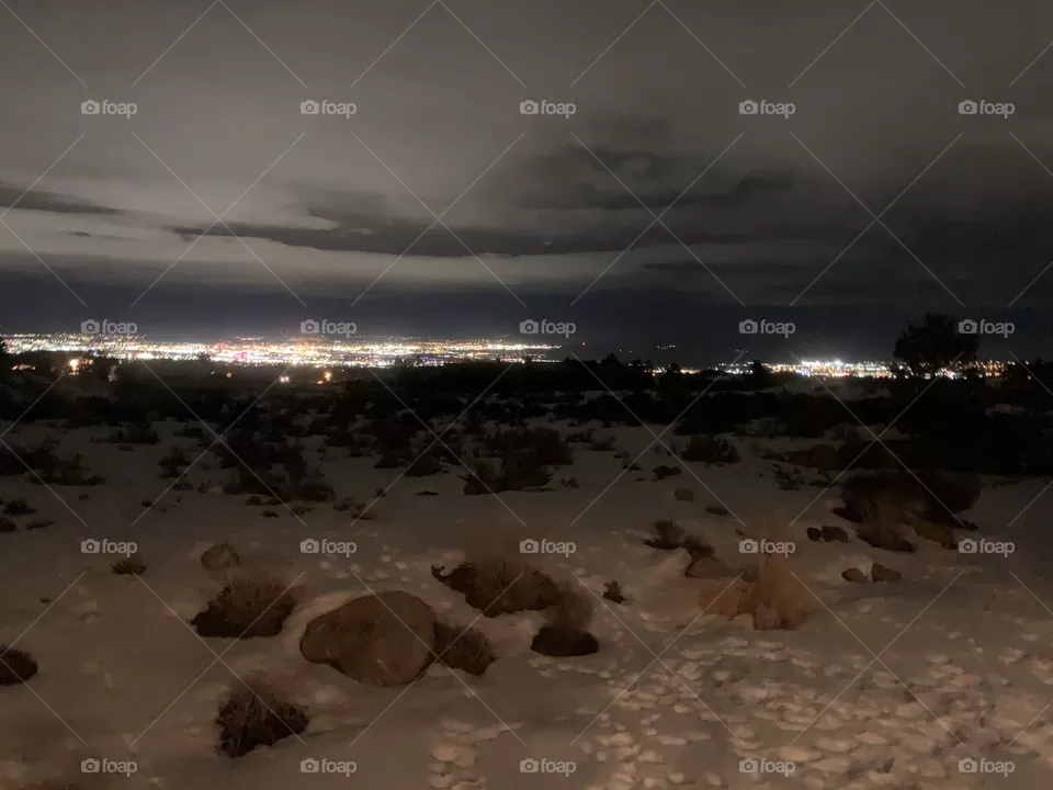 Reno city lights in the distance on a snowy night. 