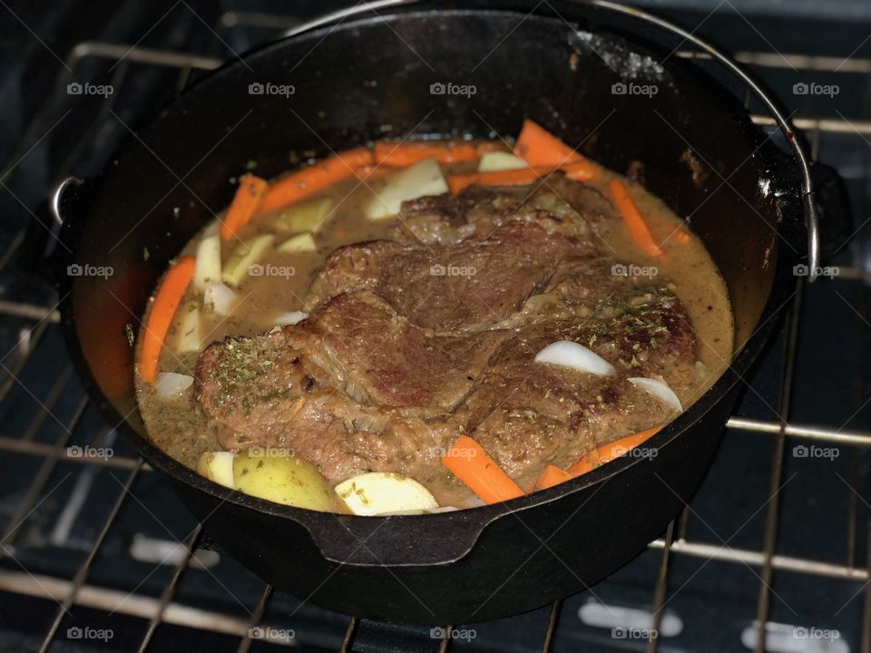 Pot roast with delicious vegetables in oven