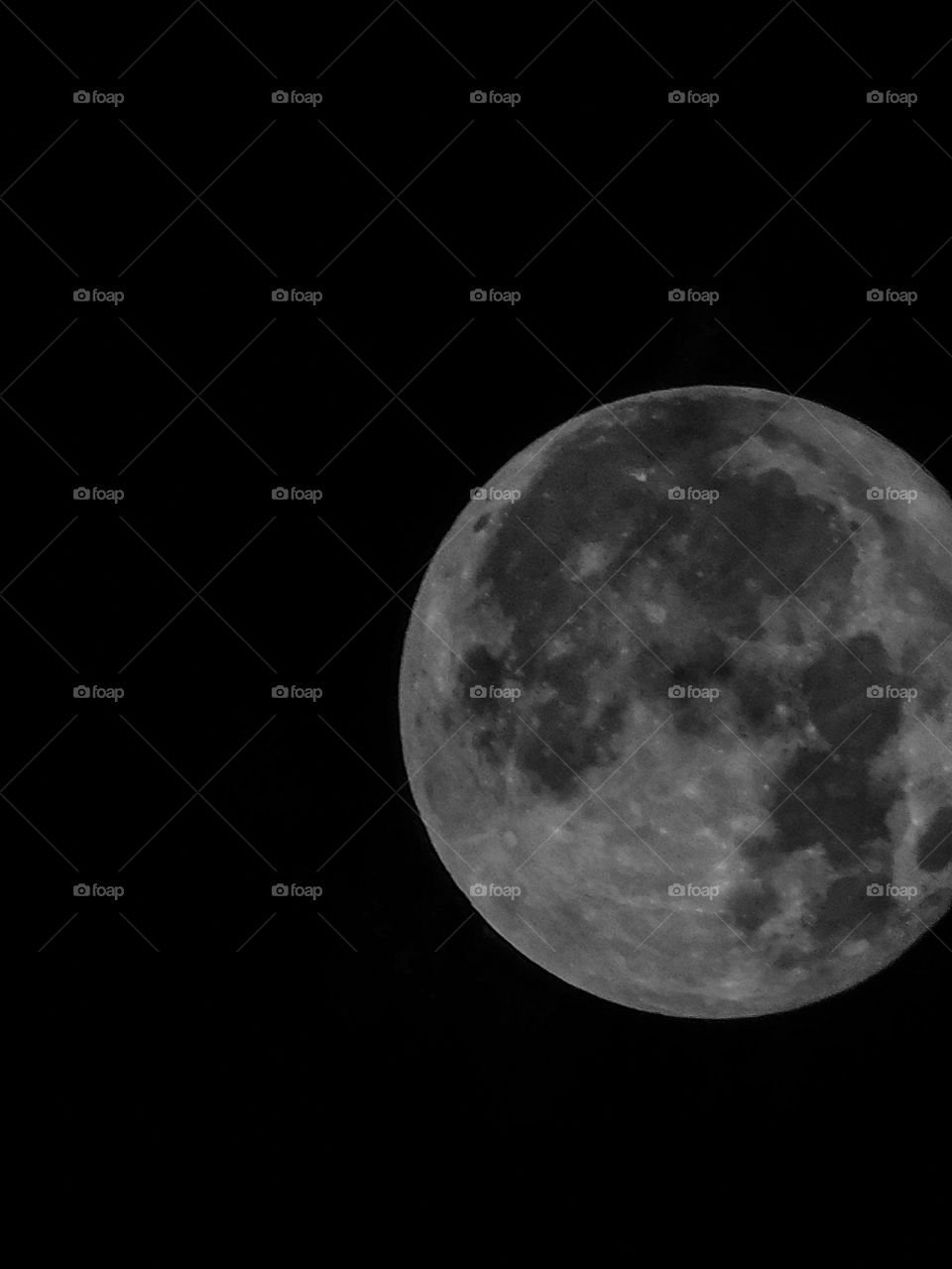 Full moon with Dark Black background having detail structure.