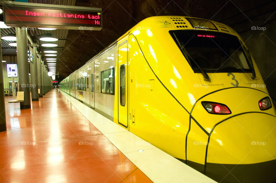sweden underground yellow train by sergiusz