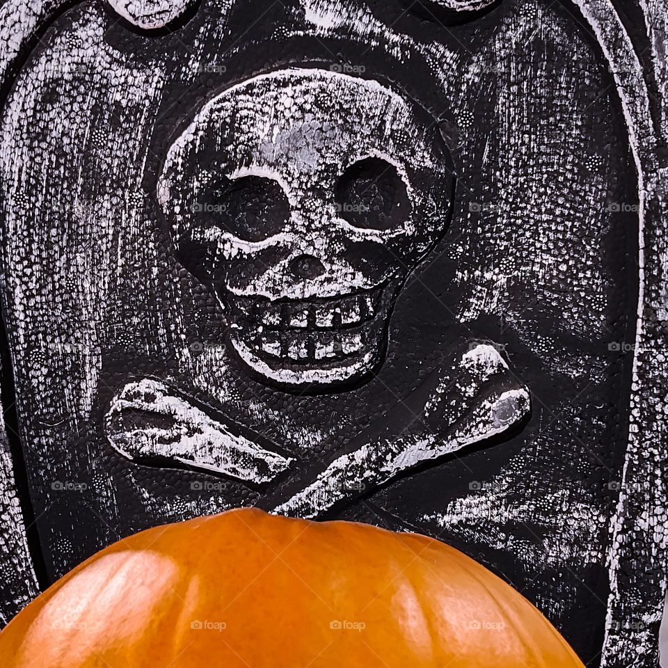Halloween pumpkin with skull and bones