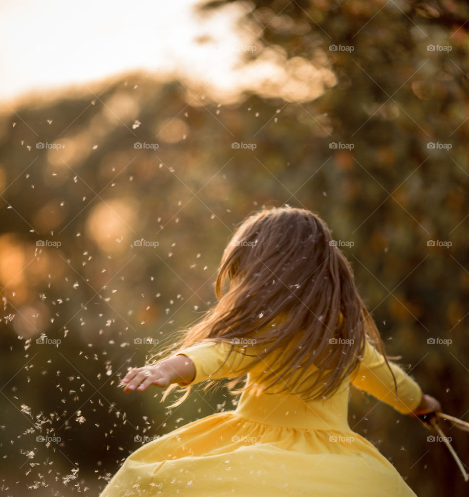 Little girl in yellow dress outdoor portrait at sunset 