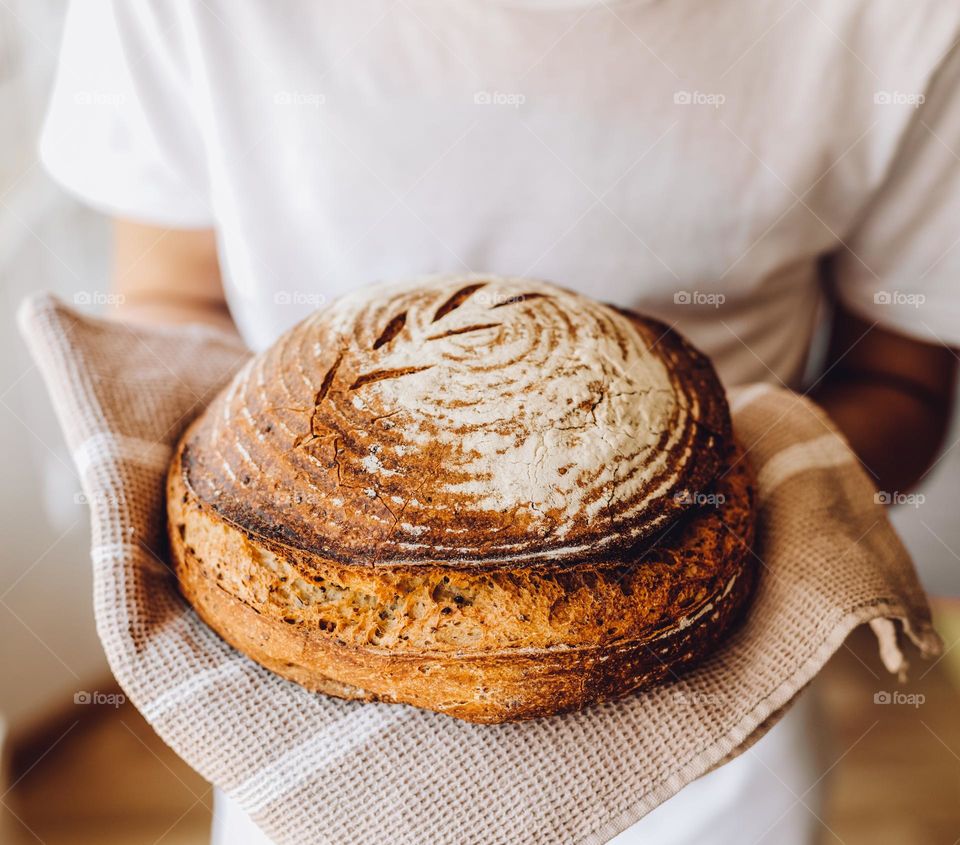 person holding handmade bread