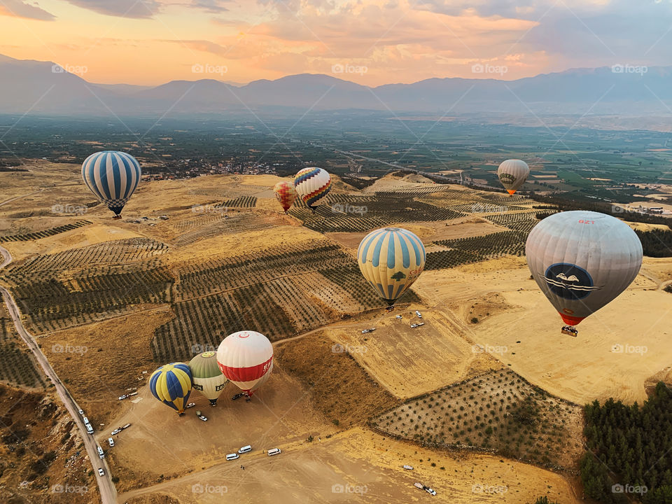 Hot air balloons flying over the beautiful landscape 