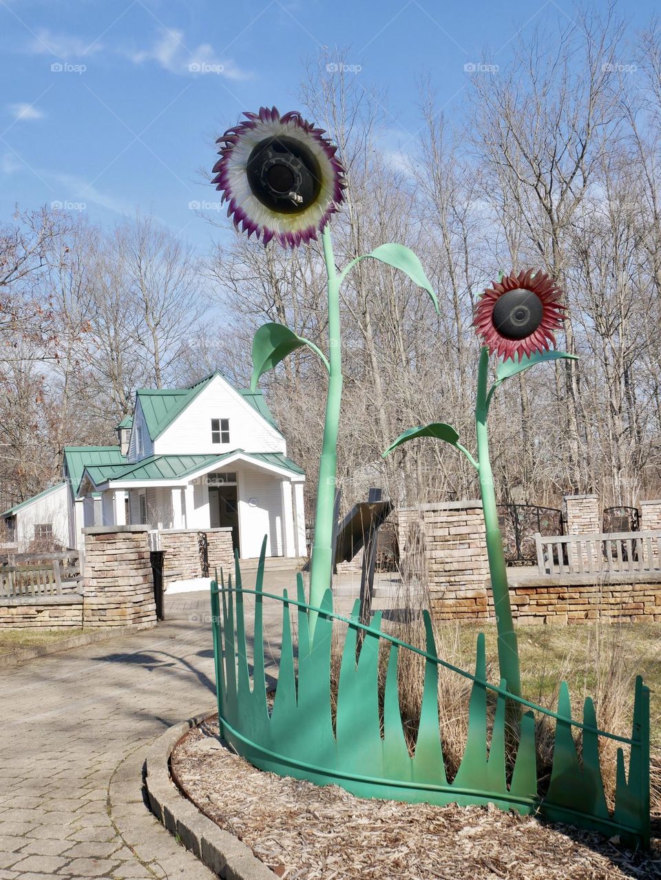 Metal sunflowers adorn a children’s vegetable garden, in a local metro park. 