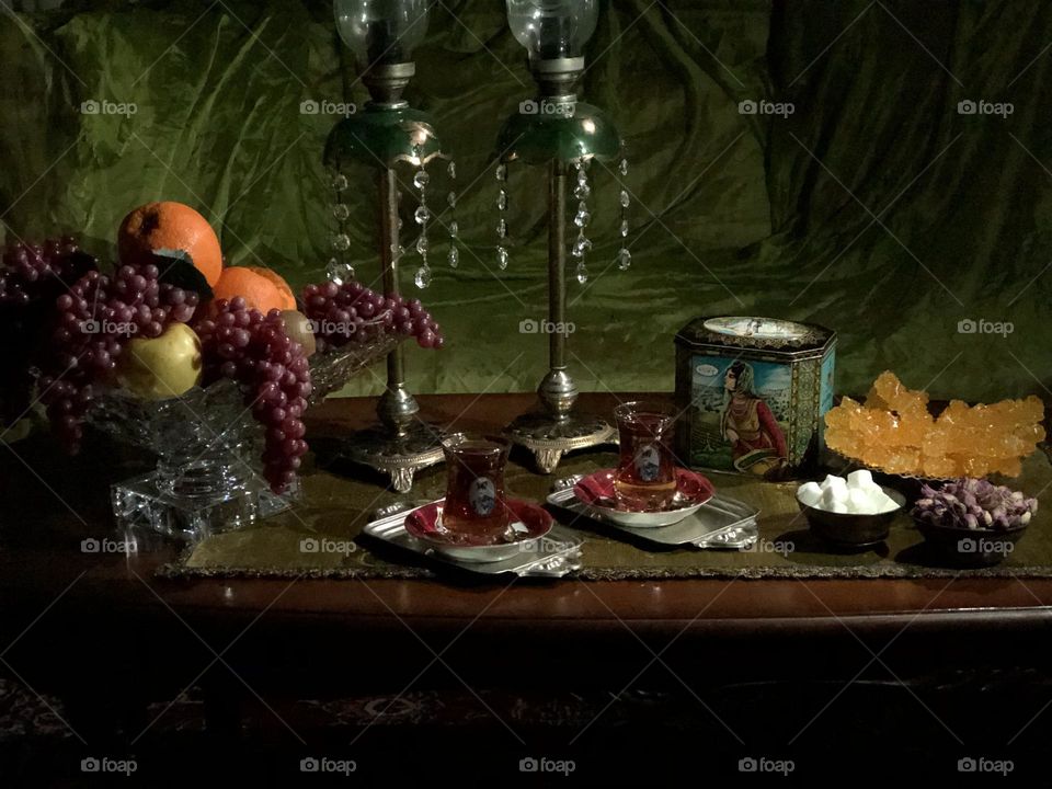 Iran has a rich culture of hospitality. Guests are welcome and considered as God's blessing. In this picture, I have tried to depict a scene called waiting for a guest. There are some items that many Iranians might find nostalgic, e.g., چای ایران.