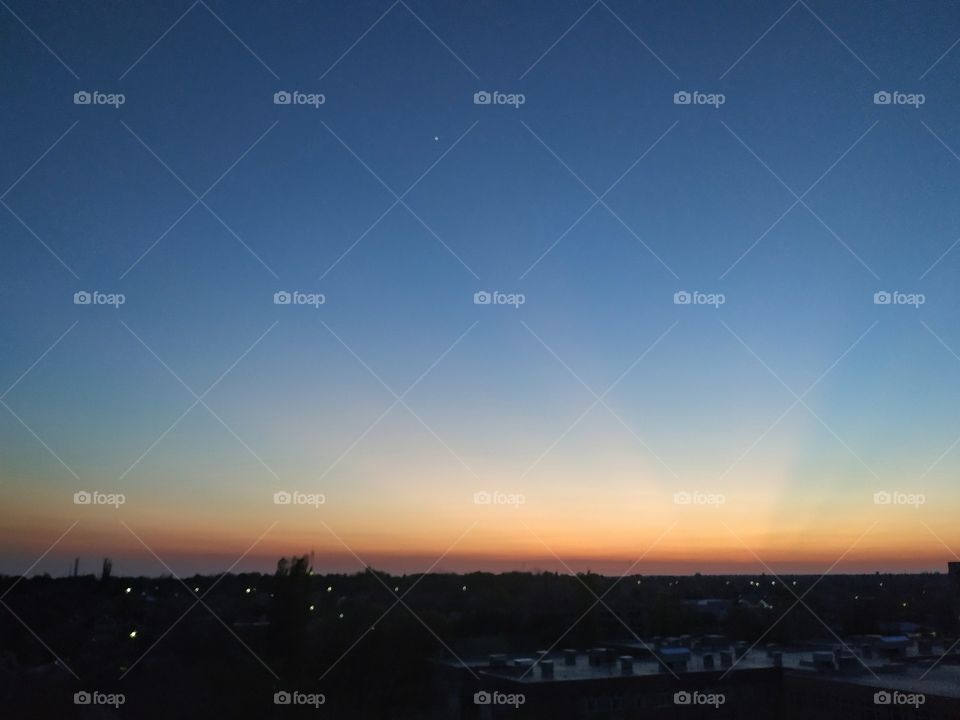 Orange sun rays and the first star