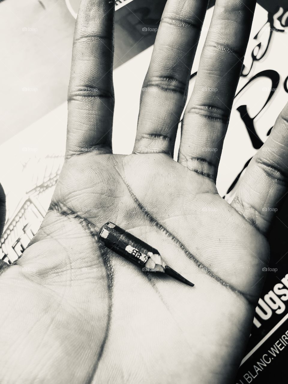 Holding a smaller used pencil in palm