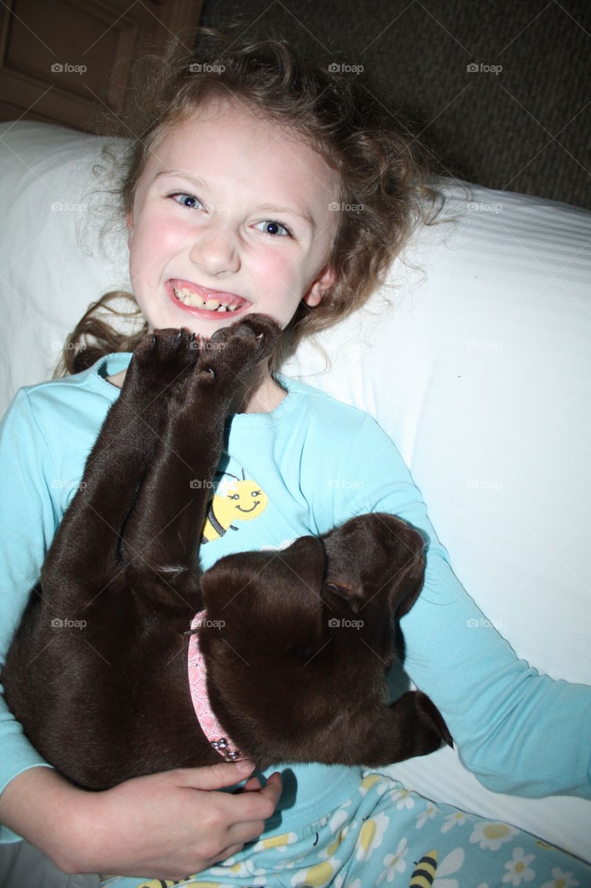 Girl and her best friend, her chocolate lab, goof around 