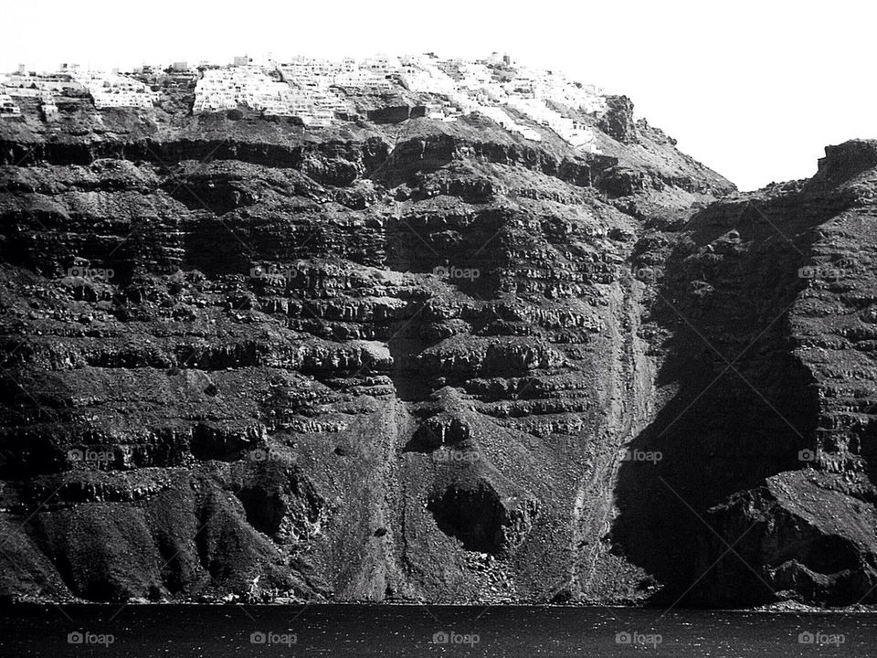 Black and white Santorini cliffs