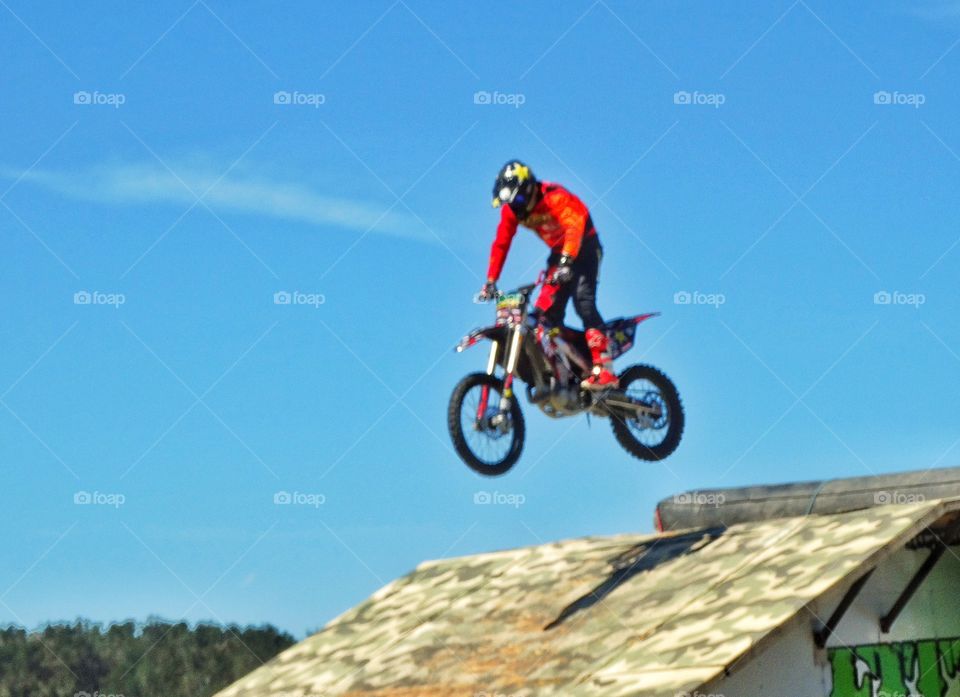 Motorcycle Stunt. Expert Rider Jumping A Motorcycle Off A Ramp
