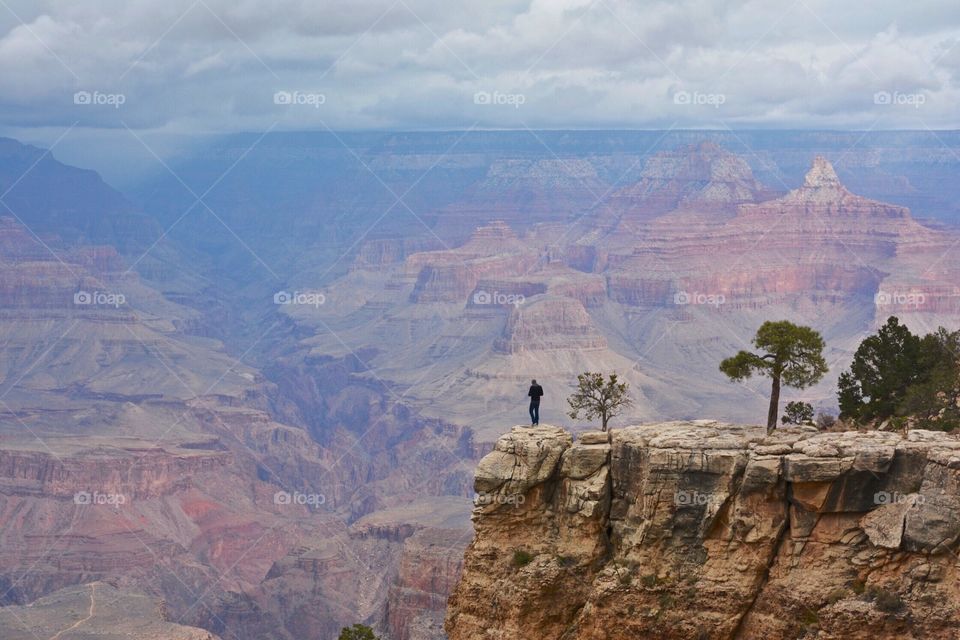 Man standing on the edge of Grand Canyon
