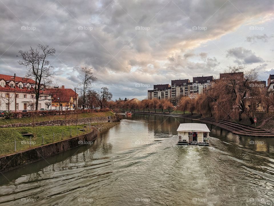 Scenic view of the old town of the Ljubljana center with boats on the river.