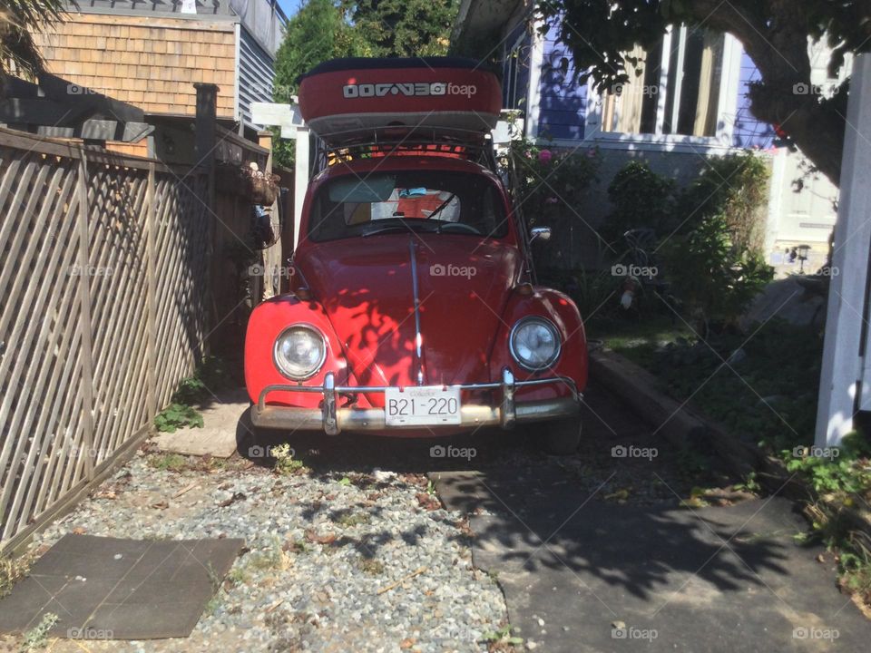 A Red Volkswagen in the Driveway 