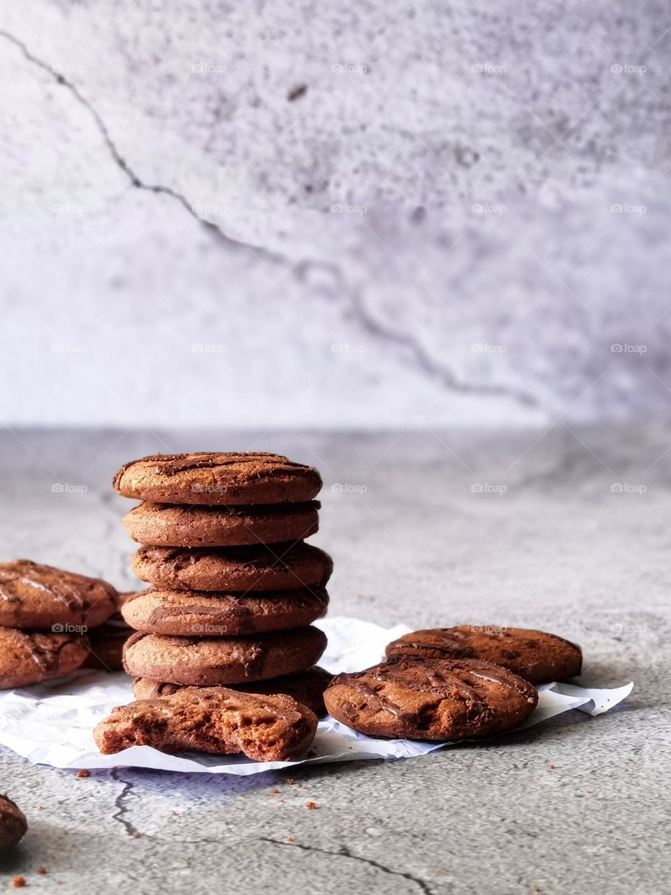 close up view of stack of chocolate cookies with white background