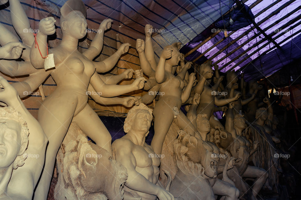 Handmade clay model of "Maa Durga" or " Devi Durga"- Hindu woman Idol close up. Snapped in the beginning of city famous Bengali festival of Kolkata or Calcutta, West Bengal, India, Asia
