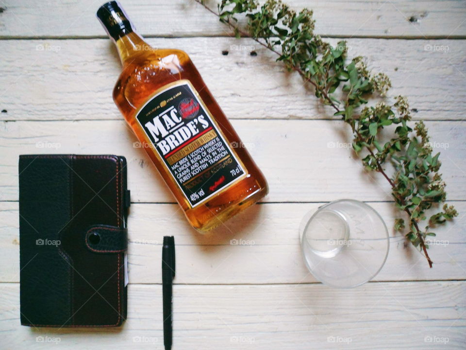 a bottle of brandy and a notebook