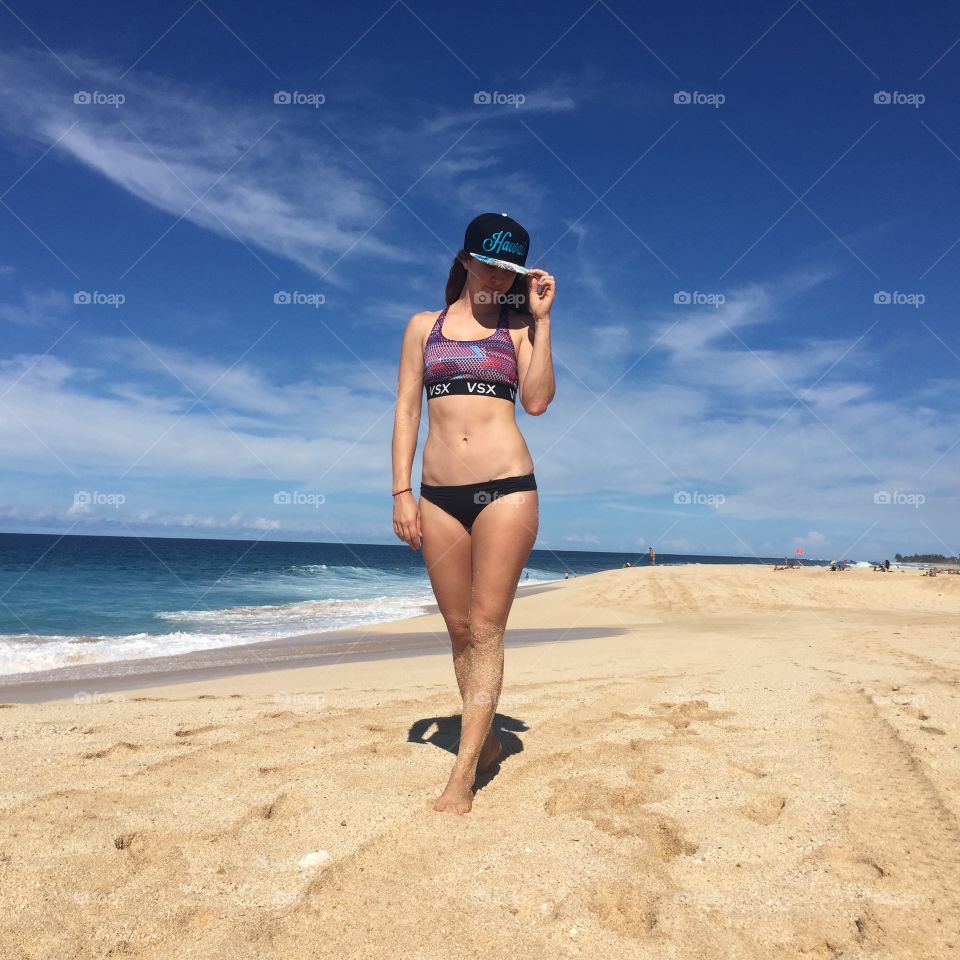 Portrait of beautiful woman standing on sandy beach