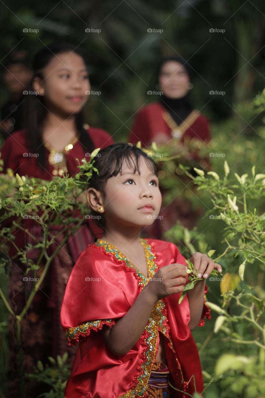 portrait of a girl wearing "LAMBUNG" clothes. "LAMBUNG" clothes are traditional clothes from Sasak Lombok, West Nusa Tenggara, Indonesia.
