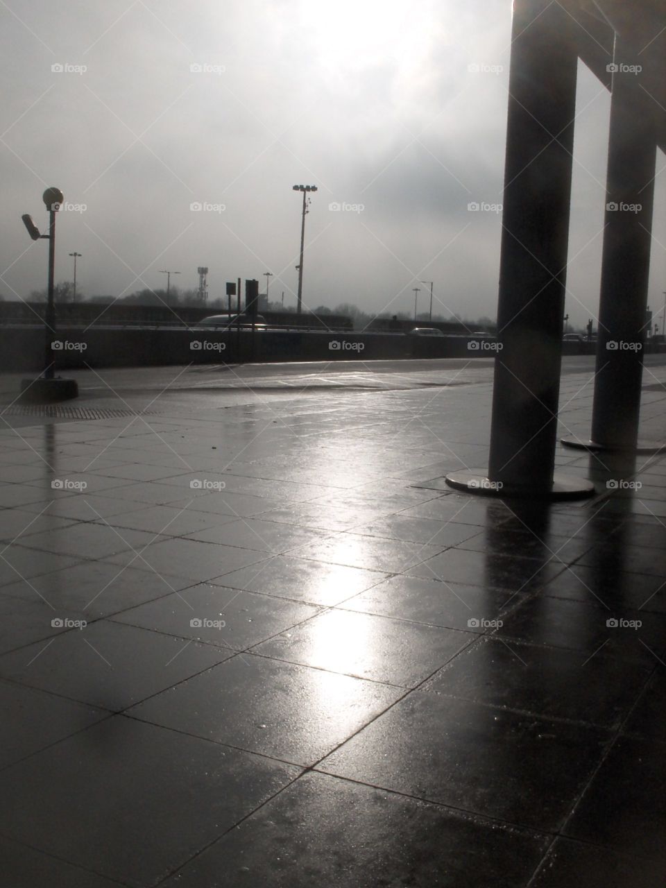 sun reflecting on wet pavement, rainy day
