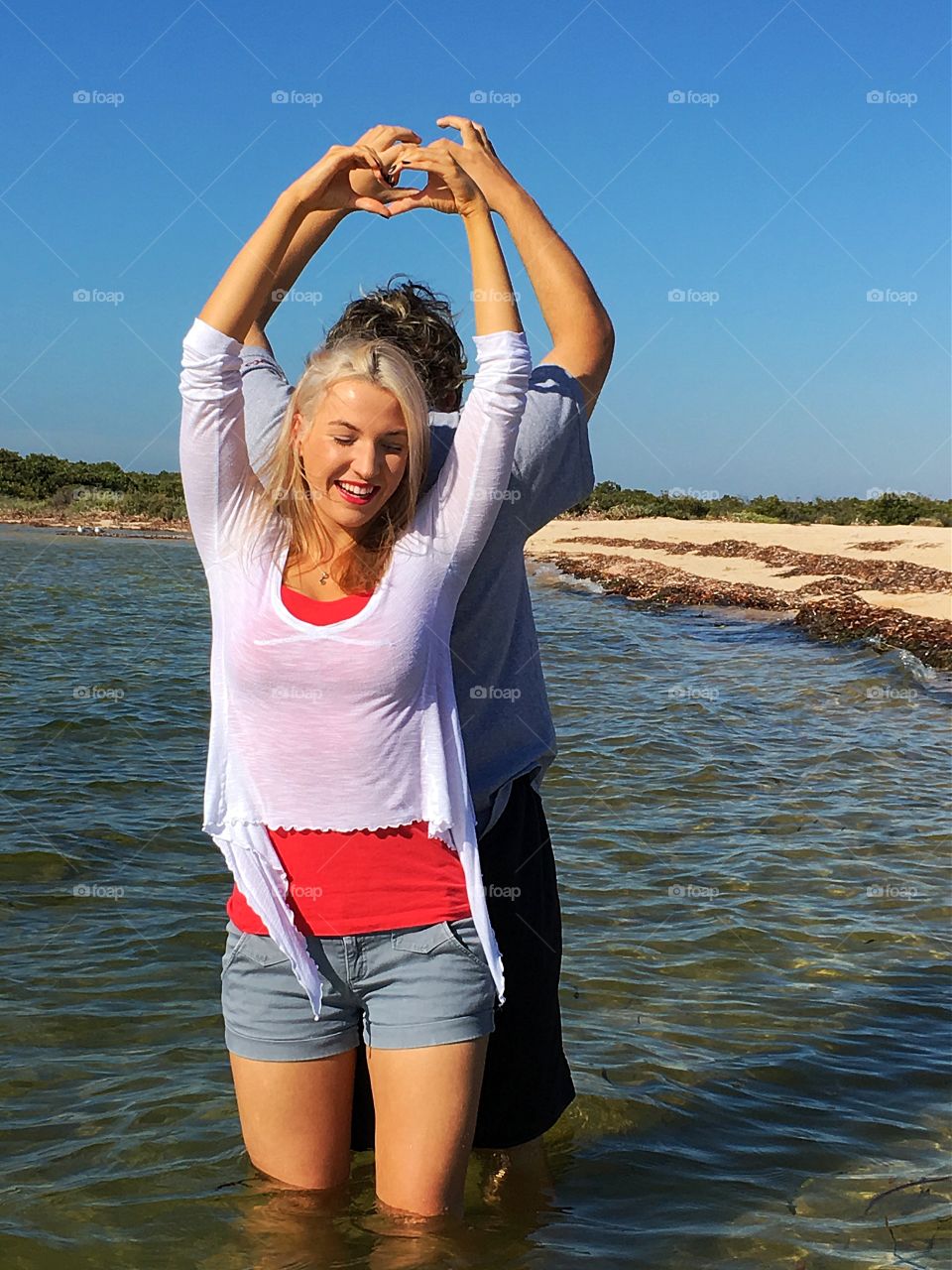 Couple making heart shape in air