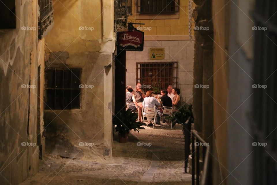 Family and friends having dinner in the street 