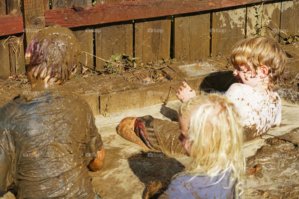 Young Brothers Playing In Mud