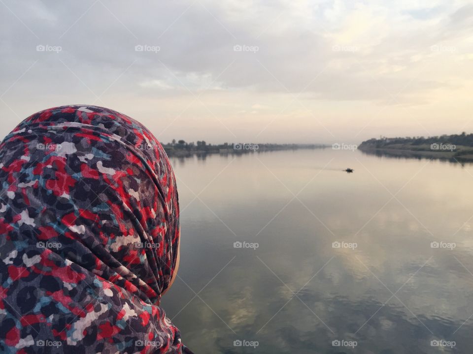 Overlooking the mirrorlike Nile river at sunset in Luxor 