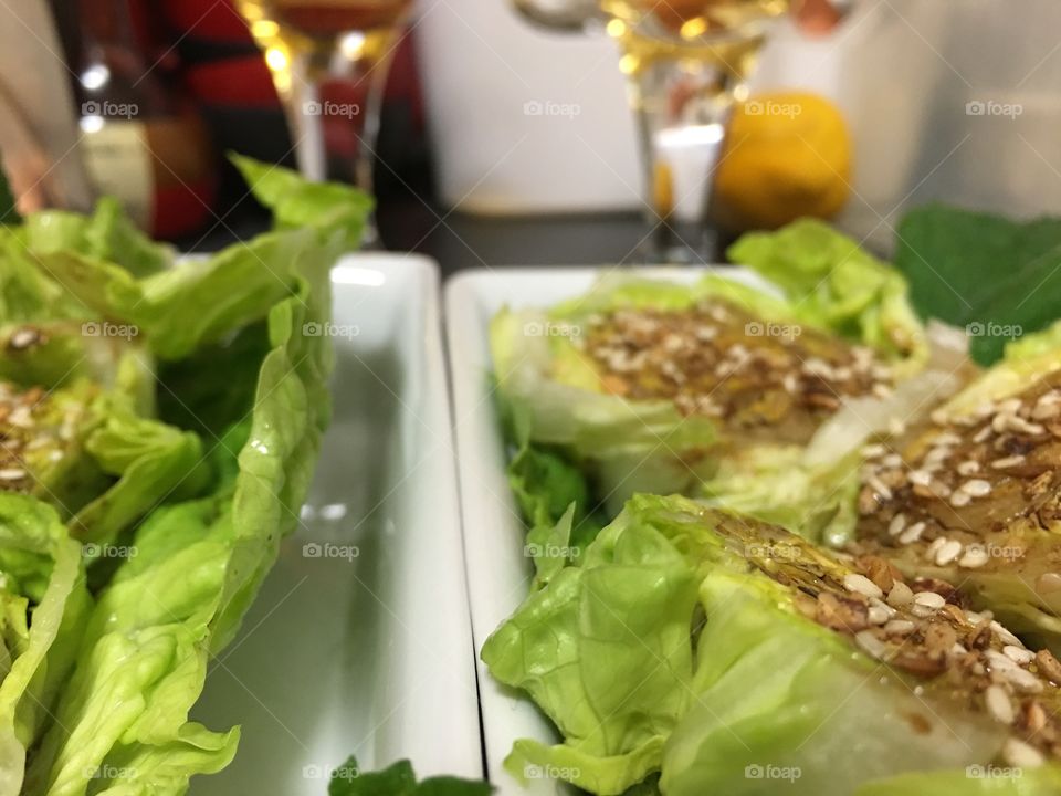 Healthy salad side dish with baby berg lettuce rounds and topped with balsamic dressing and dukkah