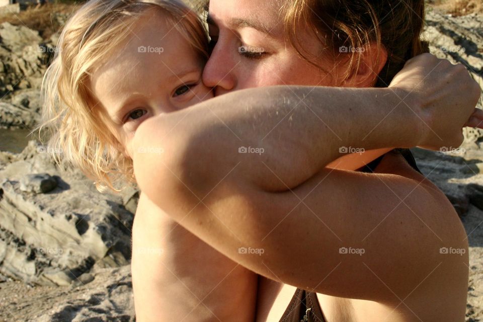 Mother and child hug and kiss