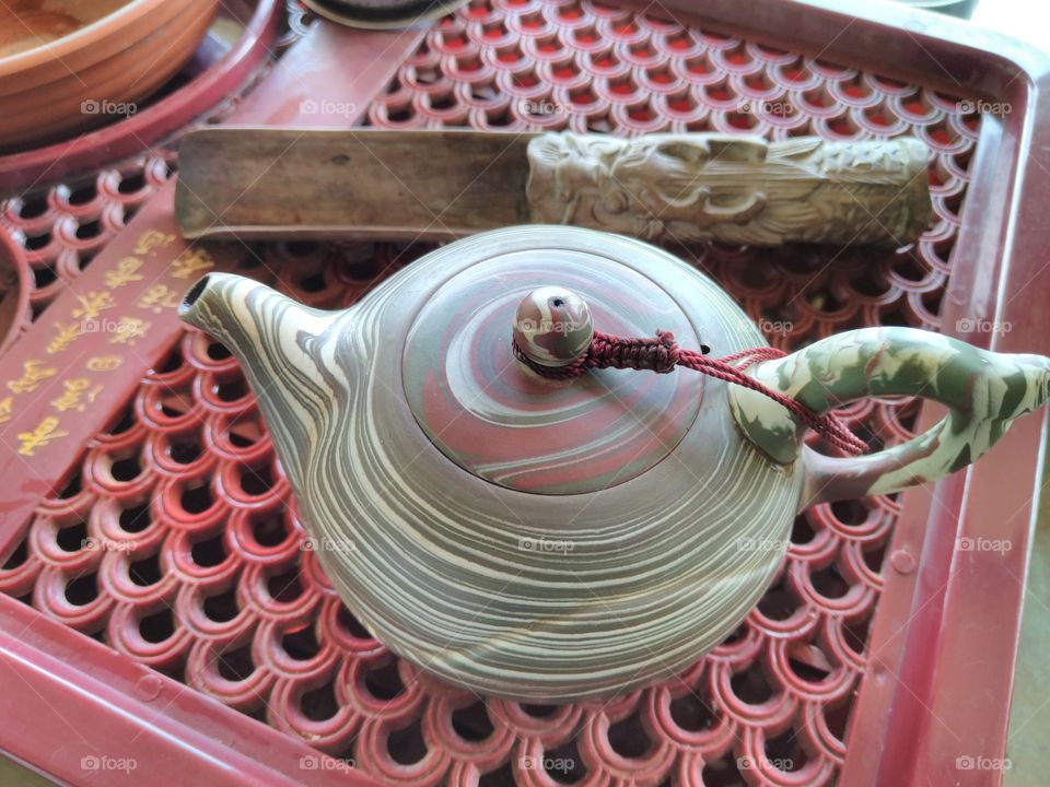 a shiny colored tea pot
