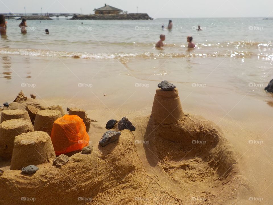 Volcanic rock on sandcastle 