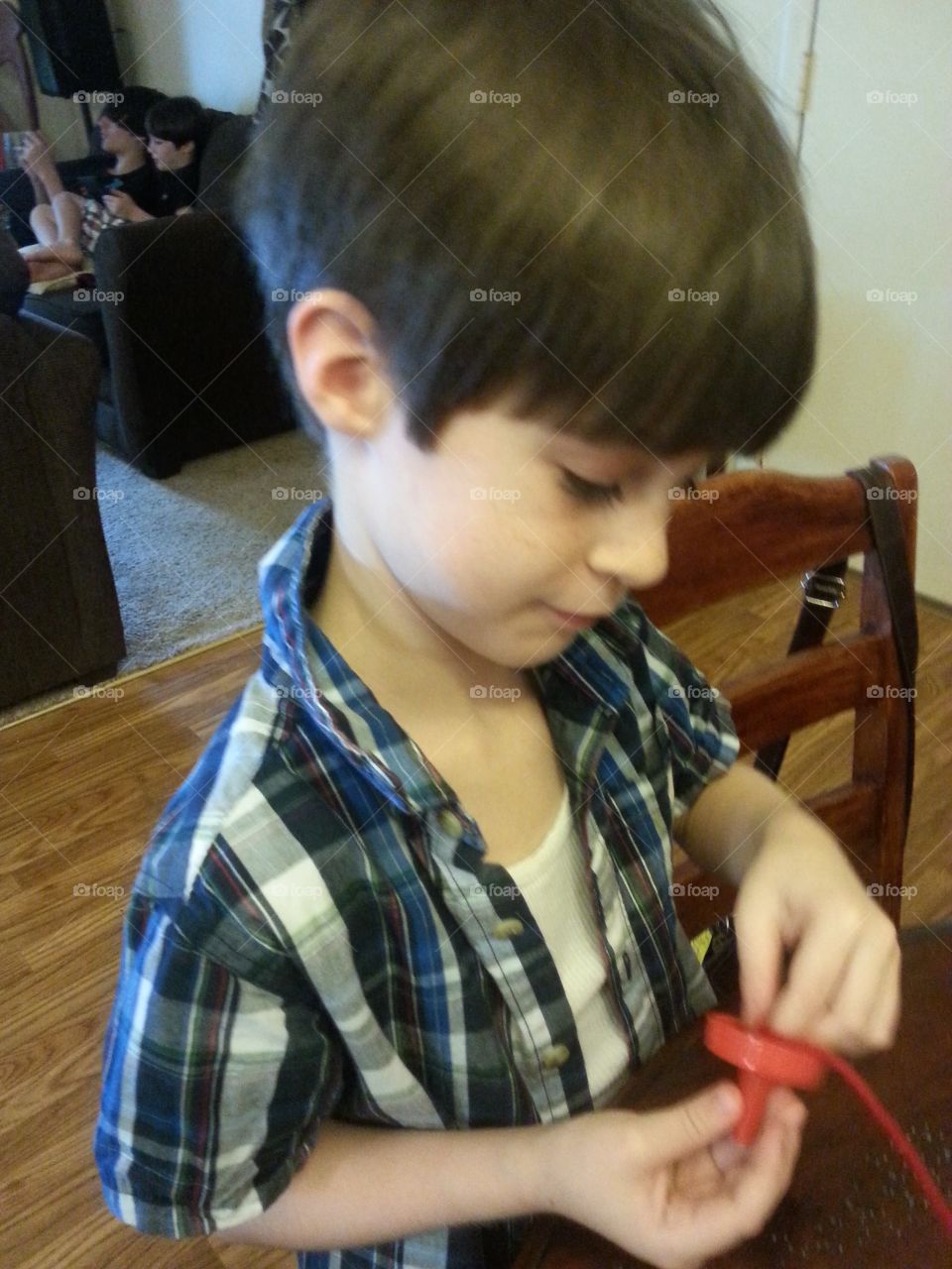  Cute Little boy looking at something in his hand.