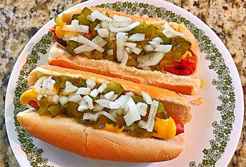 All beef hotdogs with raw onions and sweet pickle relish and mustard 