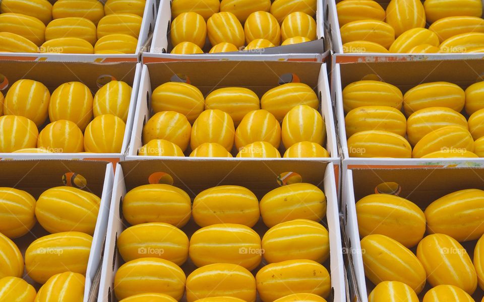 An abundance of yellow Korean melons being sold on the street in Manhattan's Chinatown, New York City.