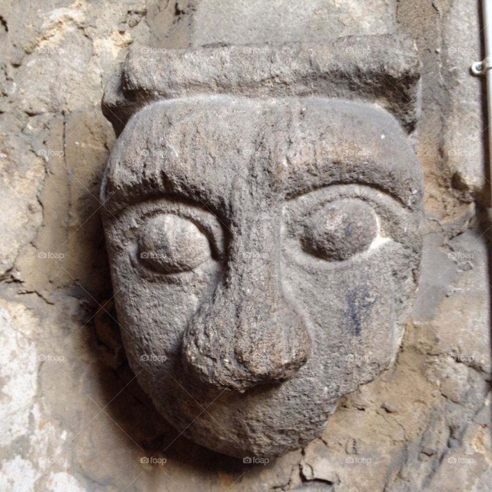 The head/face of an odd-looking gargoyle, found on the wall of Ely Cathedral in Cambridgeshire. I couldn't work out if he was carved without a mouth, or if it had dropped or been knocked off.