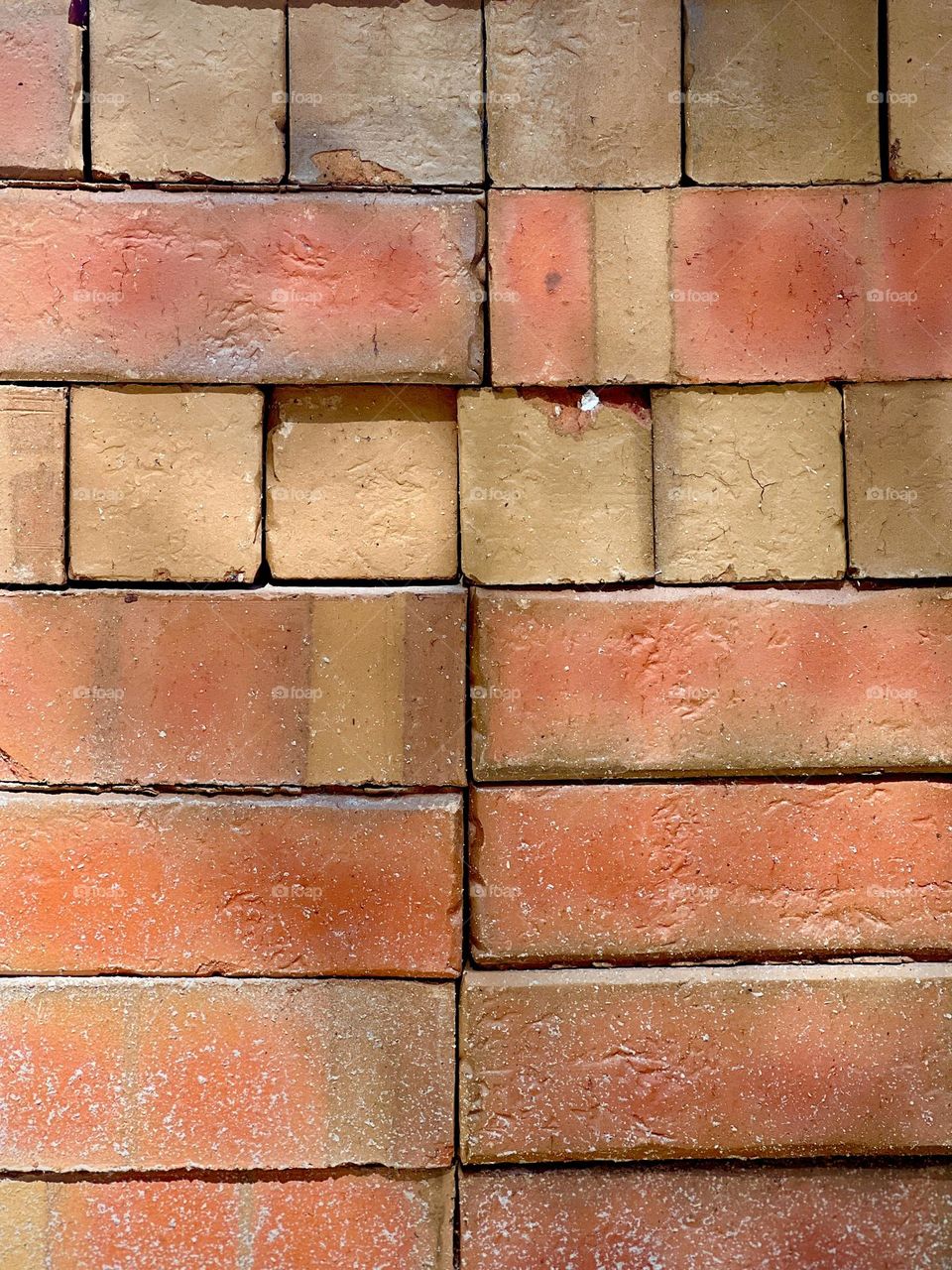Full frame stack of red and ochre bricks