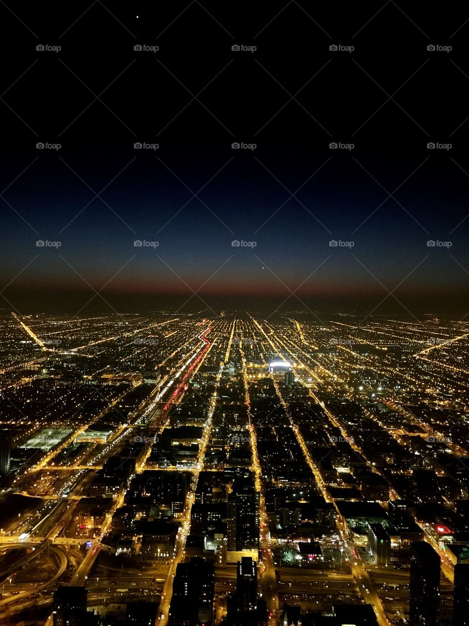 Near the top of the Willis Tower in Chicago, Illinois... you can truly see what the “twilight hour” means. Beautiful linear highways and streets light a path towards a mid western sunset.
