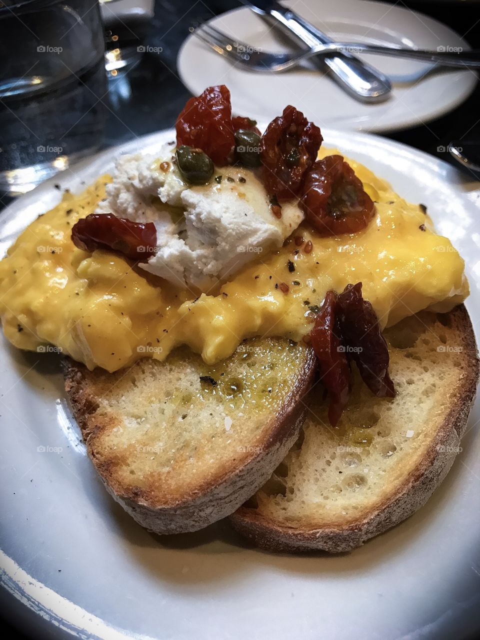 Scrambled eggs with goat cheese and sun dried tomato.