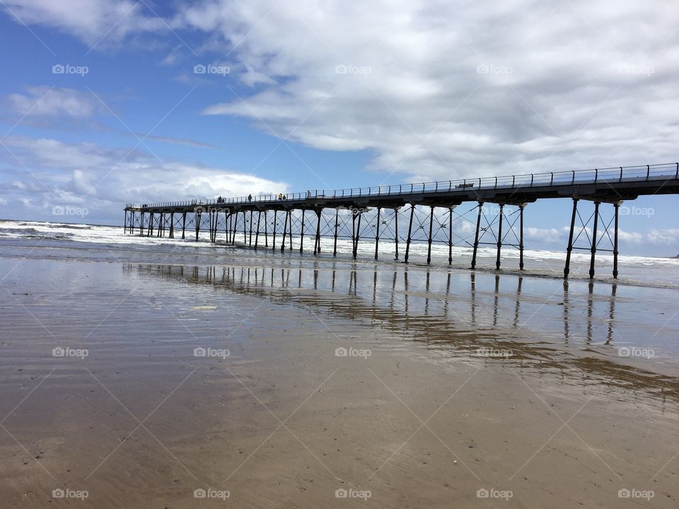 Walking towards the end of the pier ... love the reflection in the water of the many leg supports this old pier has ....