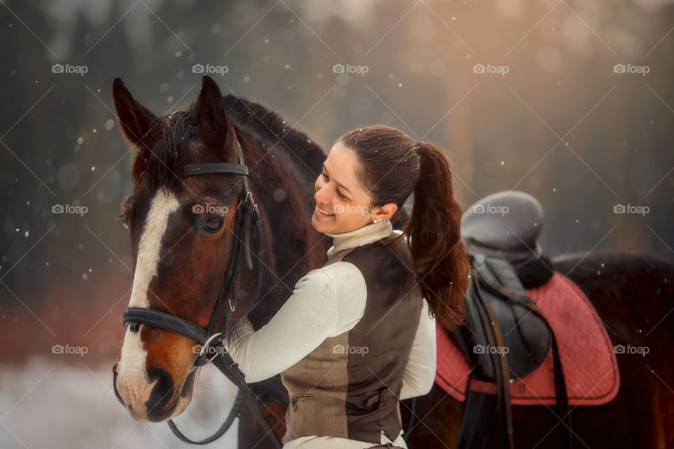 Young beautiful woman with horse outdoor portrait at spring day