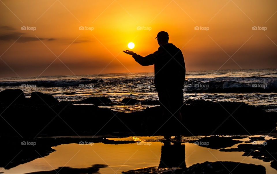 Sunrise person holding the sun