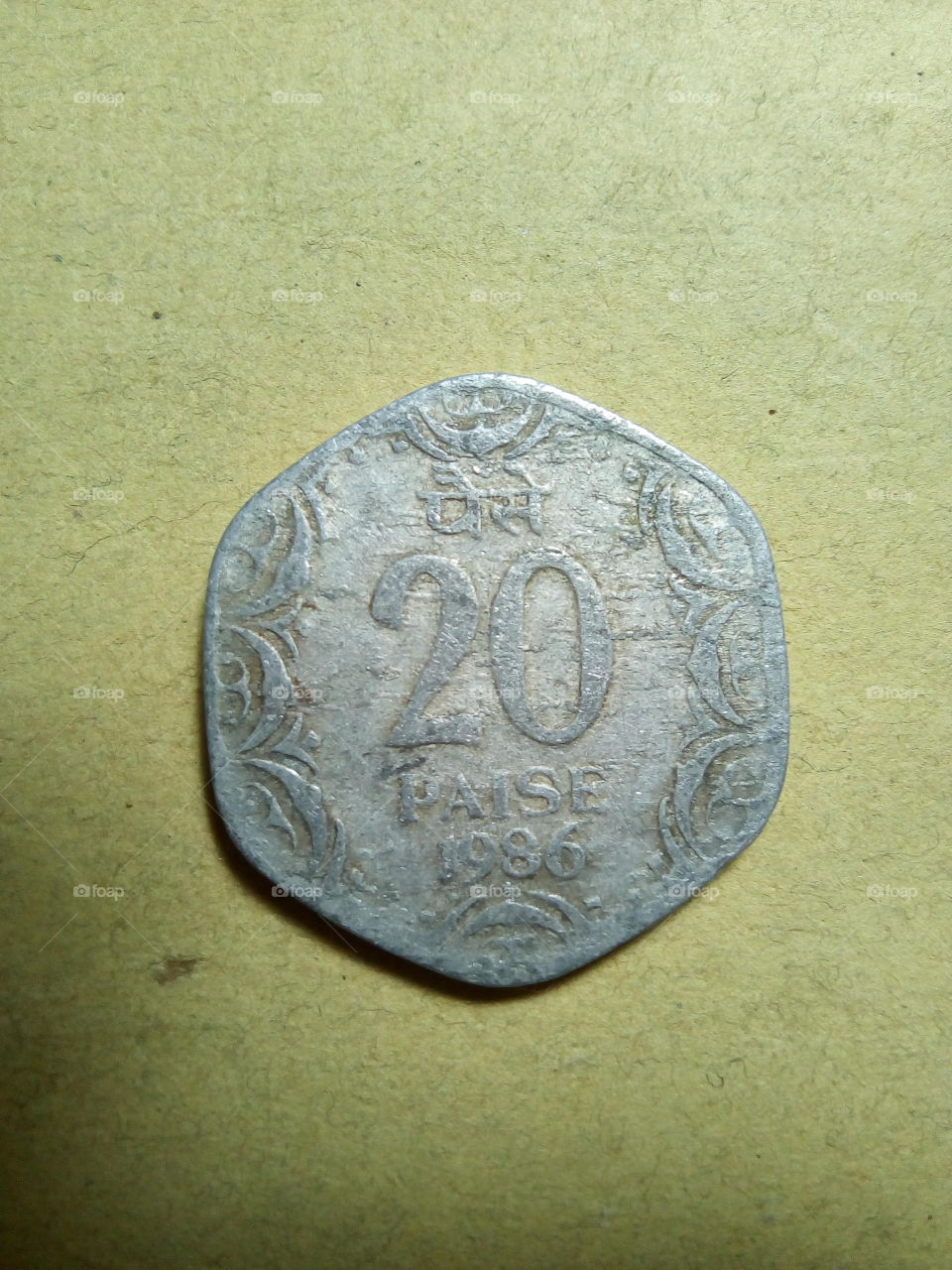 A coin of twenty paise- 1/5 share of Indian Rupee issued by Government of India in 1986.