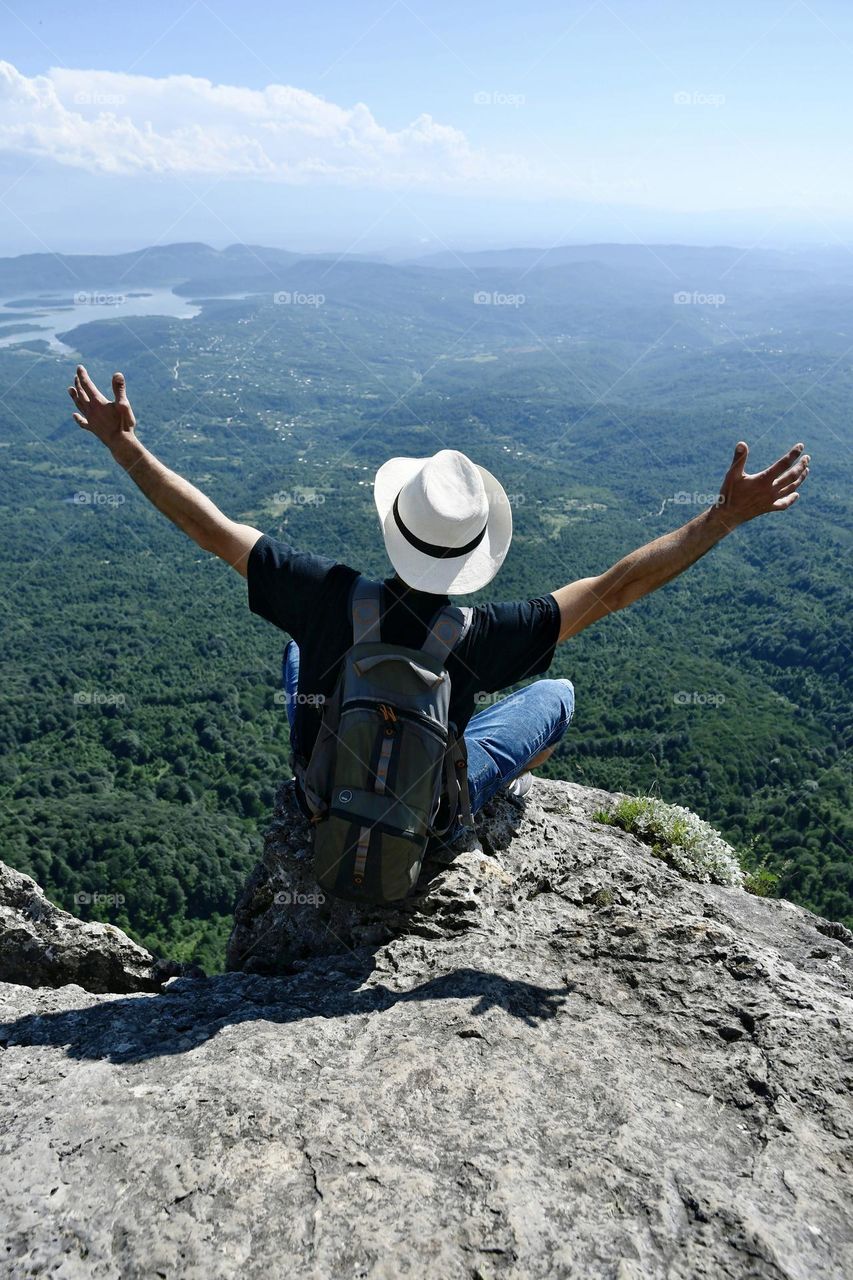 Person sitting on a cliff 