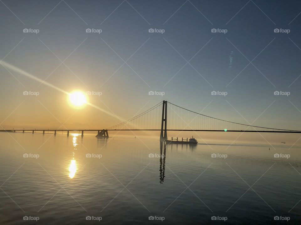 Baltic Sea with a bridge and ship on a golden sunset