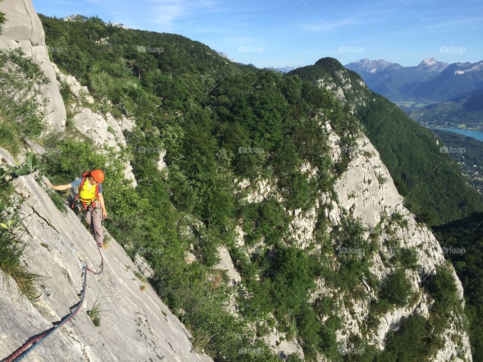 Climber above lake Annecy, France