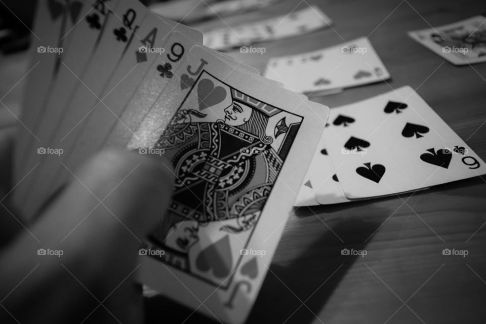 Close-up of person's hand holding playing cards