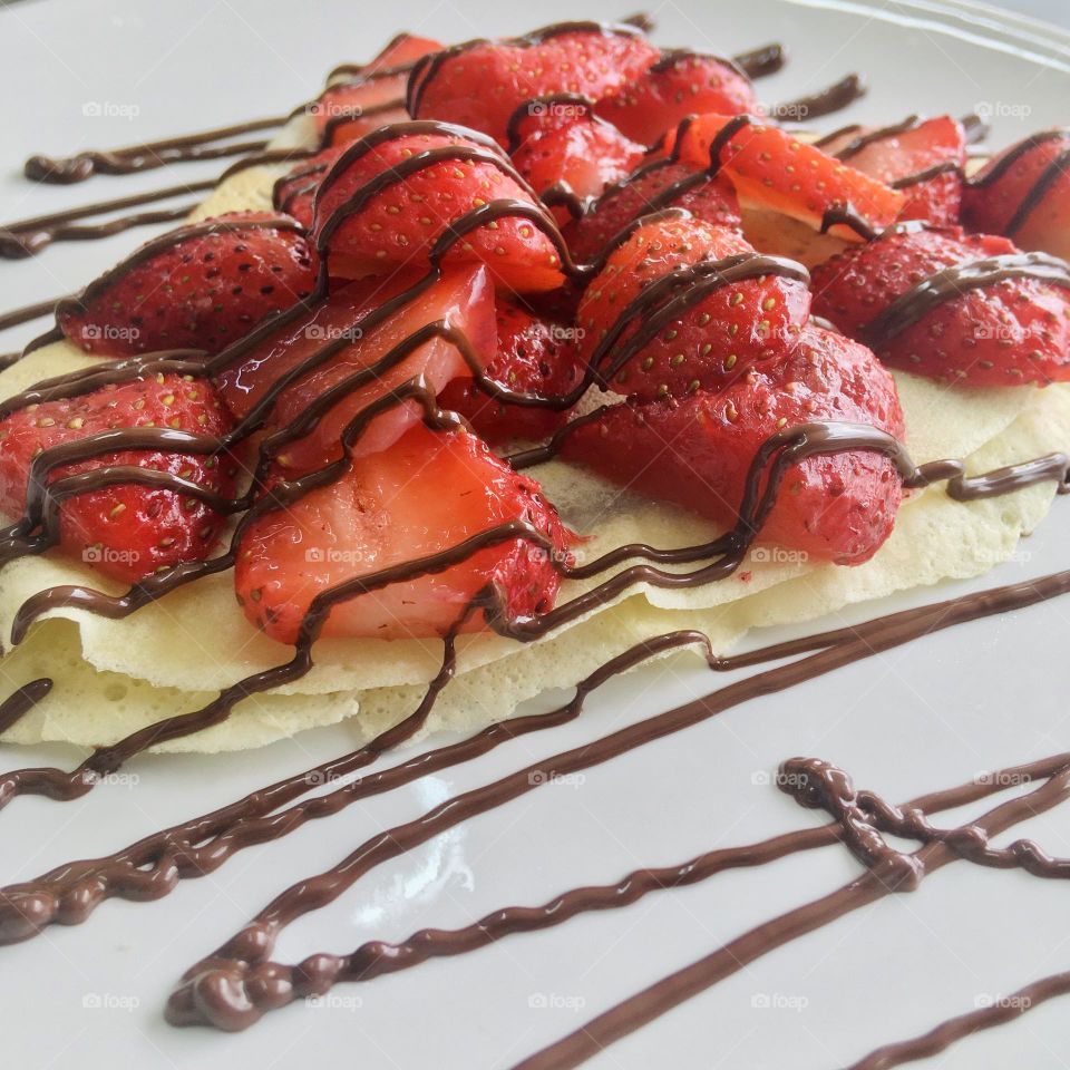 Delicious crepes with fresh strawberries on top 