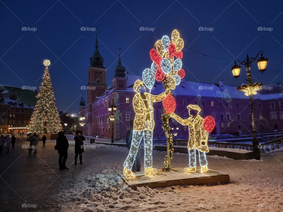 Christmas decorations around the Royal Castle in the Old Town of Warsaw, Poland: light projection, Christmas tree, light decoration