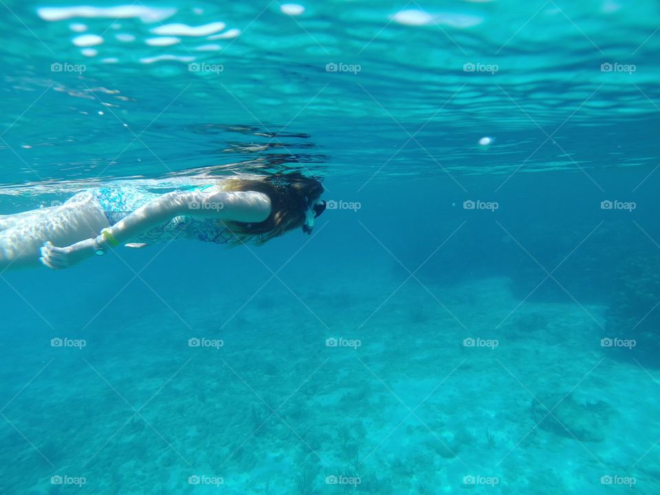 Just snorkeling by in a clear world of blue turquoise waters
